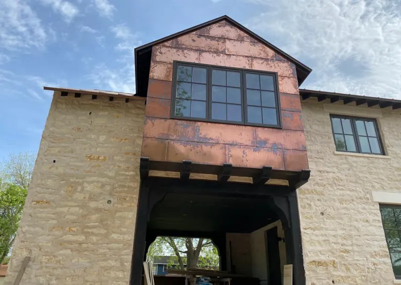 Copper metal panel facade on a stone building for Skylight Installation in Colebrookdale